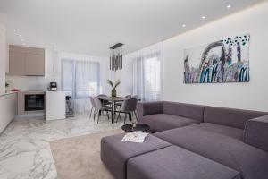 a living room with a couch and a table at HADRIE LUXURY RESORT AND VILLAS ROVA ed in Vantačići