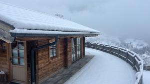 a log cabin with snow on the roof at Chalet Hittli 1065 - secret spot for unique vacay - inkl Gästekarte in Fliess