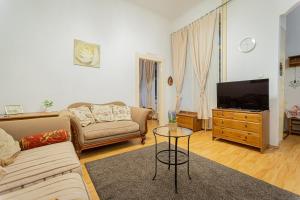 a living room with a couch and a tv at Jackquaters Silver in Budapest