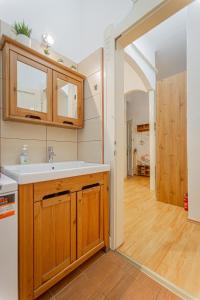 a kitchen with a sink and an open hallway at Jackquaters Silver in Budapest