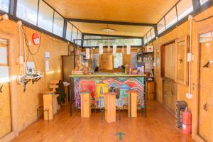 a restaurant with a bar with a painting on it at Glamping El Obrador Tilcara in Tilcara