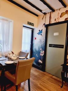 a living room with a dining room table and a door at Kethla House in Torquay