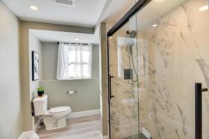 a bathroom with a toilet and a glass shower stall at Pet-Friendly South Kingstown Home 5 Mi to Beach! in South Kingstown