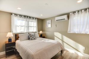a bedroom with a bed and two windows at Pet-Friendly South Kingstown Home 5 Mi to Beach! in South Kingstown