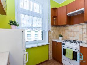 a kitchen with a white stove and a window at Dream Room in Gdańsk