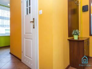 a door in a room with a yellow wall at Dream Room in Gdańsk
