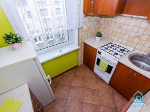 a small kitchen with a stove and a sink at Dream Room in Gdańsk