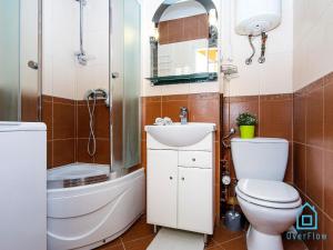 a bathroom with a toilet and a sink and a shower at Dream Room in Gdańsk