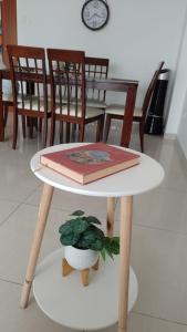 a table with a book and a plant on it at Agradable, en el centro y con cochera in Trujillo +12 photos