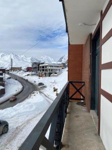 a balcony with a view of snow covered mountains at Mountain Dream House in Gudauri