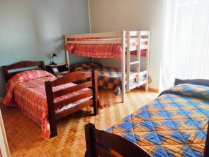 a bedroom with two beds and a bunk bed at Appartamento vacanze da Paola in Roccabruna