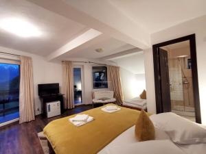 a bedroom with a large bed and a living room at Casa Tamara in Bran