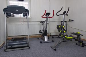 a gym with three exercise bikes in a room at Samostatný dom s bazénom v Rajeckej doline in Podhorie