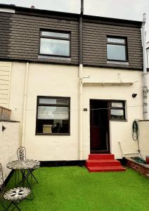 a house with a green lawn in front of it at 50 Etherley Lane in Bishop Auckland