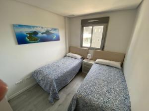 a small room with two beds and a window at Green Hills La Zenia-Luxury 3 bed Apartment in Los Dolses +37 photos
