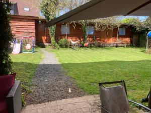 a backyard with a playground and a house at Hostal Argentina Osorno in Osorno