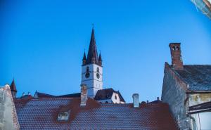 a clock tower on top of a building at Studio Sonia - Tordosan Central - #1 in Sibiu