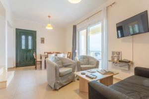 a living room with a couch and chairs and a table at Corfu Sea View Villa - Sequoia in Barbati