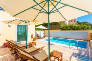 a pool with tables and chairs and an umbrella at Corfu Sea View Villa - Sequoia in Barbati