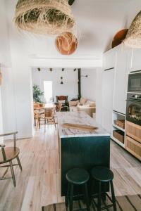 a kitchen and living room with a table and chairs at Casa Vó Briata in Mértola