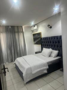 ein Schlafzimmer mit einem großen Bett in einem Zimmer in der Unterkunft Merry Villa in Lagos