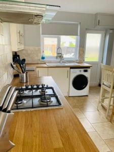 a kitchen with a stove and a counter top at Risca Inspire in Risca