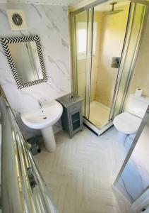 a bathroom with a sink and a toilet and a shower at Risca Inspire in Risca