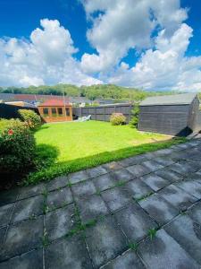 a yard with a grassy yard with a house at Risca Inspire in Risca