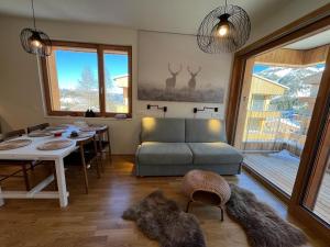a living room with a couch and a table at AlmApp Nassfeld in Sonnenalpe Nassfeld