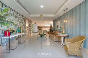 a living room with a couch and a table and chairs at Apto vista p/ rio c/ varanda - Pontal BCL402 in Ilhéus +34 photos