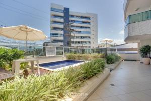 a swimming pool on the roof of a building at Apto vista p/ rio c/ varanda - Pontal BCL402 in Ilhéus
