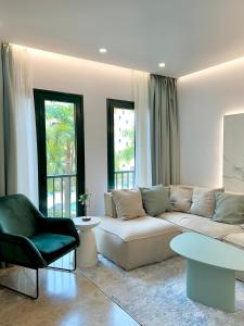 a living room with a white couch and a table at Luxury apartment San Pedro de Alcantara, Marbella, near the Sea and Golf club in Marbella