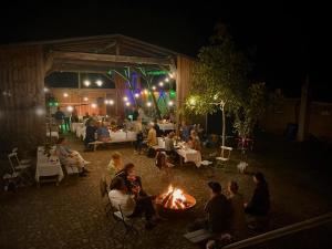 a group of people sitting around a fire at night at Altes Kommandeurhaus in Werben an der Elbe in Werben +32 photos
