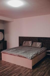 łóżko w pokoju z białą ścianą w obiekcie Apartment Panorama Gjakove w mieście Gjakove