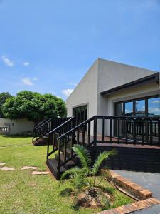 a house with a black railing on the front of it at Vintage@1420 in Ngodini