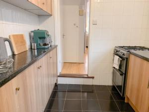 a kitchen with a counter top and a stove top oven at Cosy 3 bed home with garden - near to uni, restaurants & bars in Hull