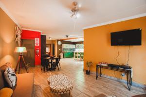 a living room with a flat screen tv on a wall at I Stay @ De 22 On Vintage in Windhoek