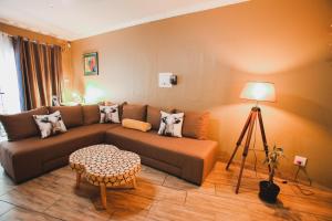 a living room with a couch and a table at I Stay @ De 22 On Vintage in Windhoek