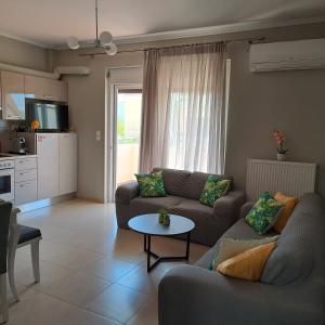 a living room with a couch and a table at Lefkada CP Residences in Lefkada Town