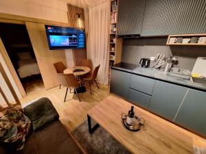 a living room with a couch and a table at Grand Casa Apartments in Jahorina