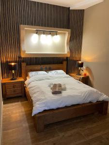 a bedroom with a large bed with two lights on it at Private Garden House in Haifa