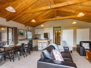 a living room with a couch and a table at Ski Country Chalet - Ohakune Holiday Home in Ohakune