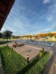 a park with a picnic table and benches and palm trees at Casa de praia Luís Correia in Luis Correia