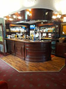 a bar in a pub with a wooden floor at The Bank House Hotel in Uttoxeter
