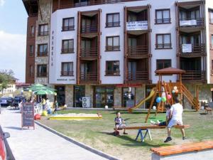 a large building with a playground in front of it at Predela 1 in Bansko