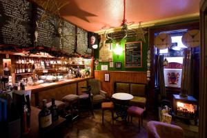 a bar with a table and chairs in a room at The Anderson in Fortrose