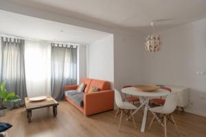 a living room with a couch and a table at Casita Coqueta Free Parking in Cádiz