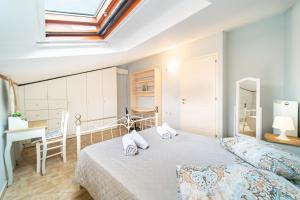 a bedroom with a bed and a desk and a window at Maisonette in Corfu Town