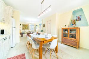 a kitchen and dining room with a table and chairs at Maisonette in Corfu Town