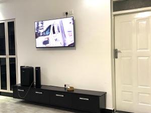 a living room with a flat screen tv on the wall at CACECY LUXURY HOMES in Bungoma